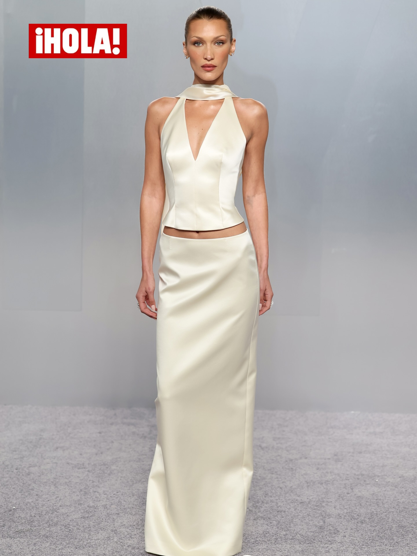 Bella Hadid makes a striking appearance at an after-party following the Academy Awards in Los Angeles, wearing a sleek ivory look that creates a minimalist yet eye-catching silhouette for the night