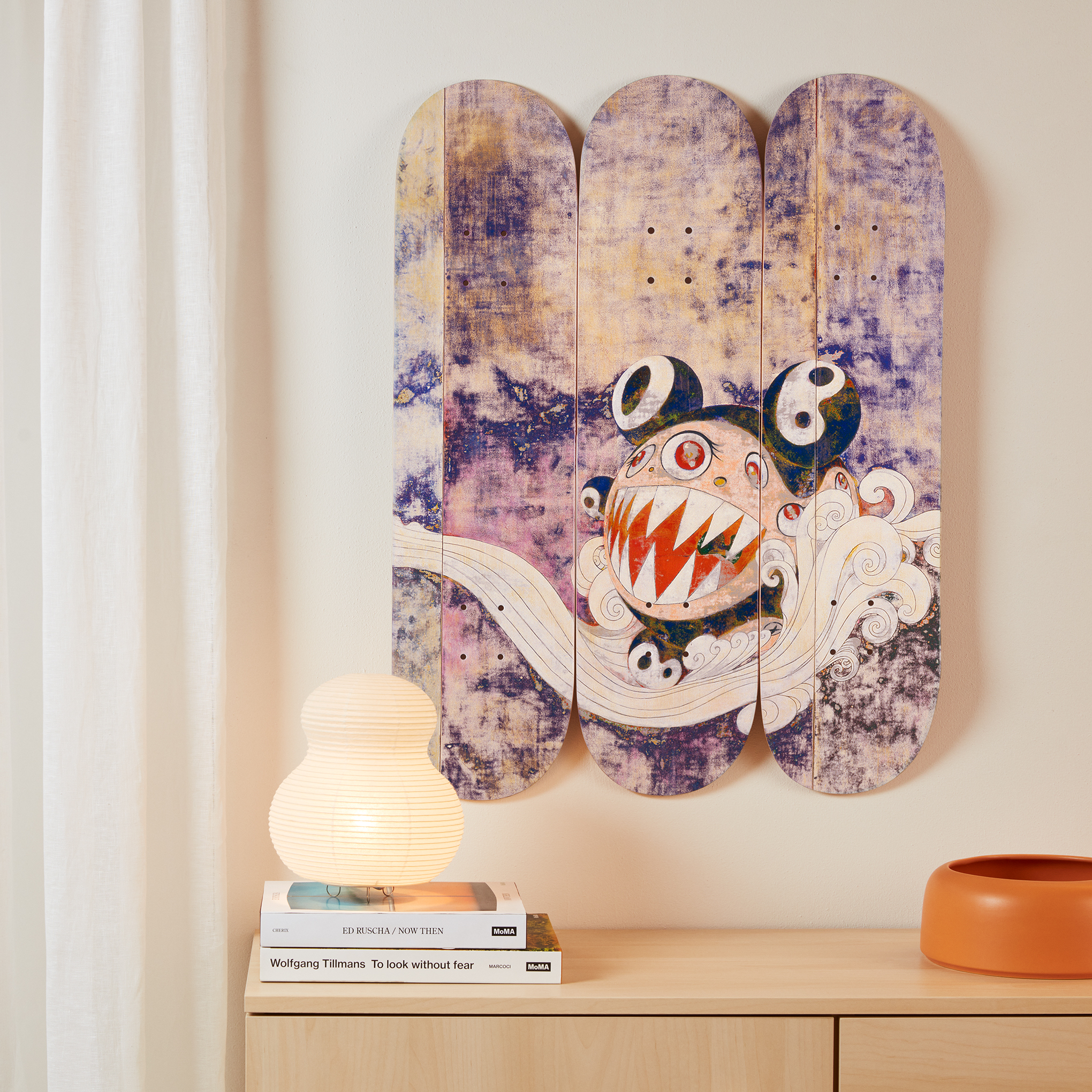 This skateboard triptych features a reproduction of “727” (1996