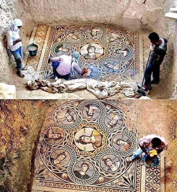A worker cleans the 2,200-year-old Muzas (Muses) mosaic in the