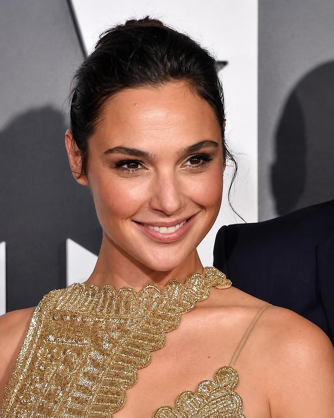 gal gadot gold dress glowing on the red carpet in a stunning gold-and-silver look — elegant, confident, and effortlessly classic. The full-body shot brings the whole outfit together, while the close-ups show that warm gal gadot green dress
