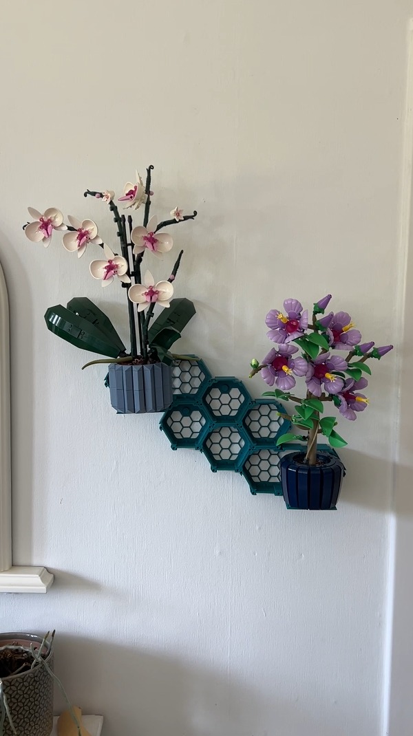 Two LEGO Botanicals on the wall, Orchid (10311) and Hibiscus