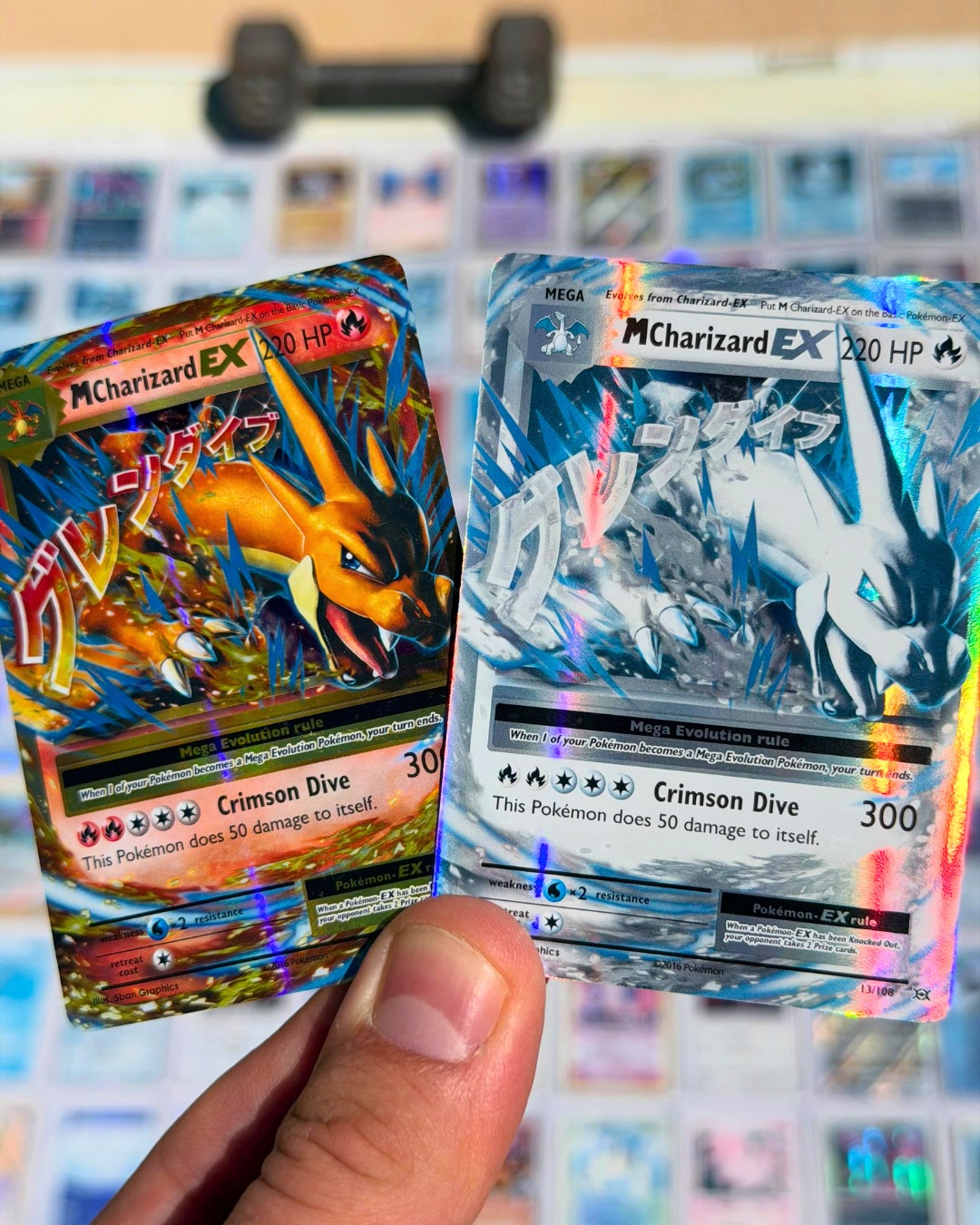 A sunbleached Charizard card held next to the original version  
