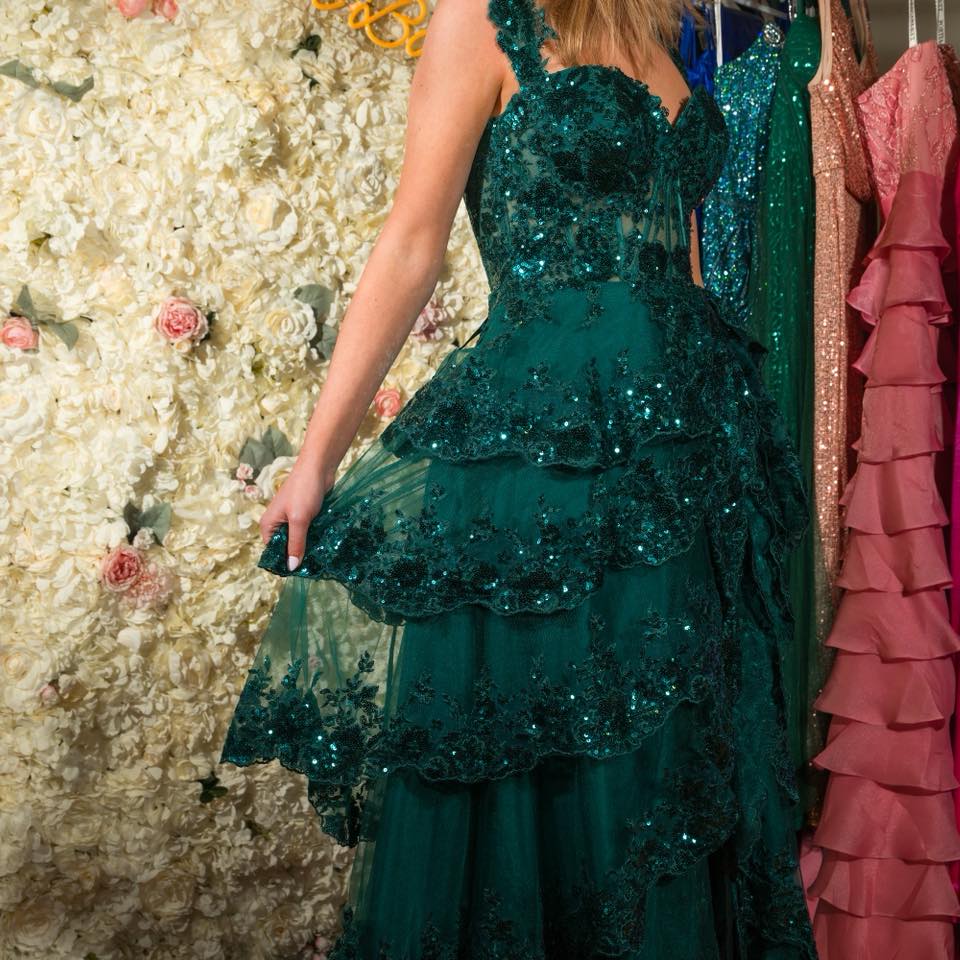 enchanted green dress 🌳✨ The lovely Hanna in our ruffle Adora Design dress! Complete with embroidered floral sequins, high slit, and corset back! Style 3174 Shop prom today No Appointment Necessary! 119 N Rose Gold Sequin
