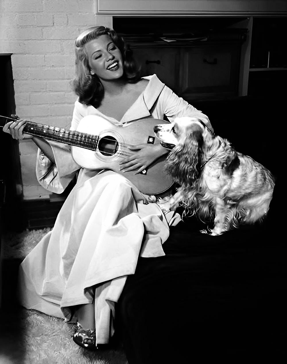 Rita Hayworth in 1948 with guitar and dog
