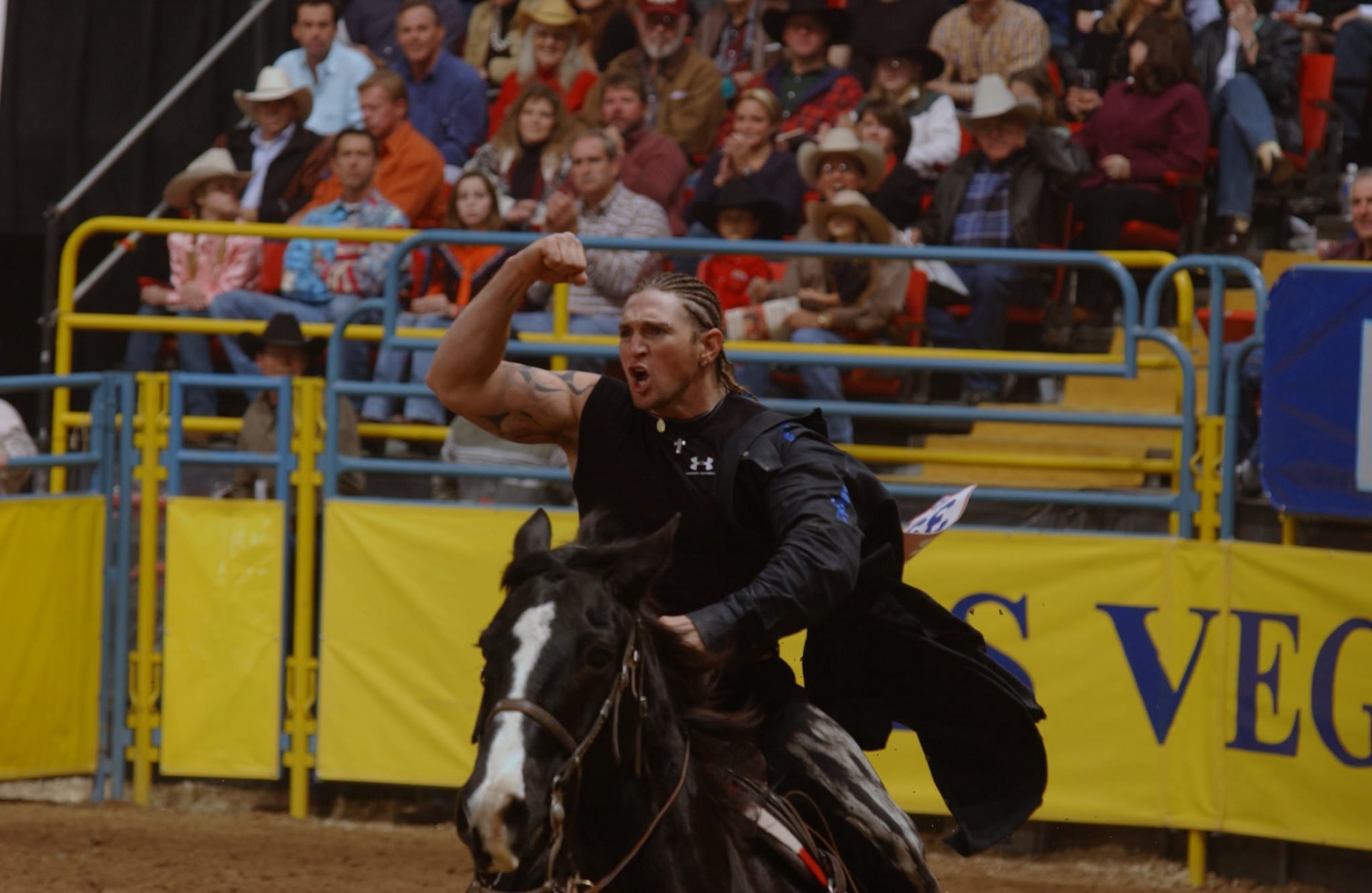 Super Sid Steiner flexing during his victory lap at the 2002 NFR