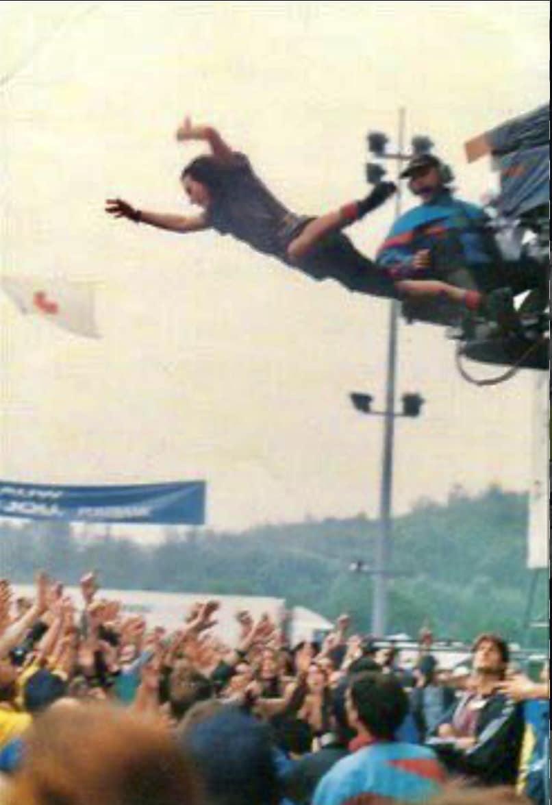 Eddie Vedder of Pearl Jam jumping into the crowd at Pinkpop 92