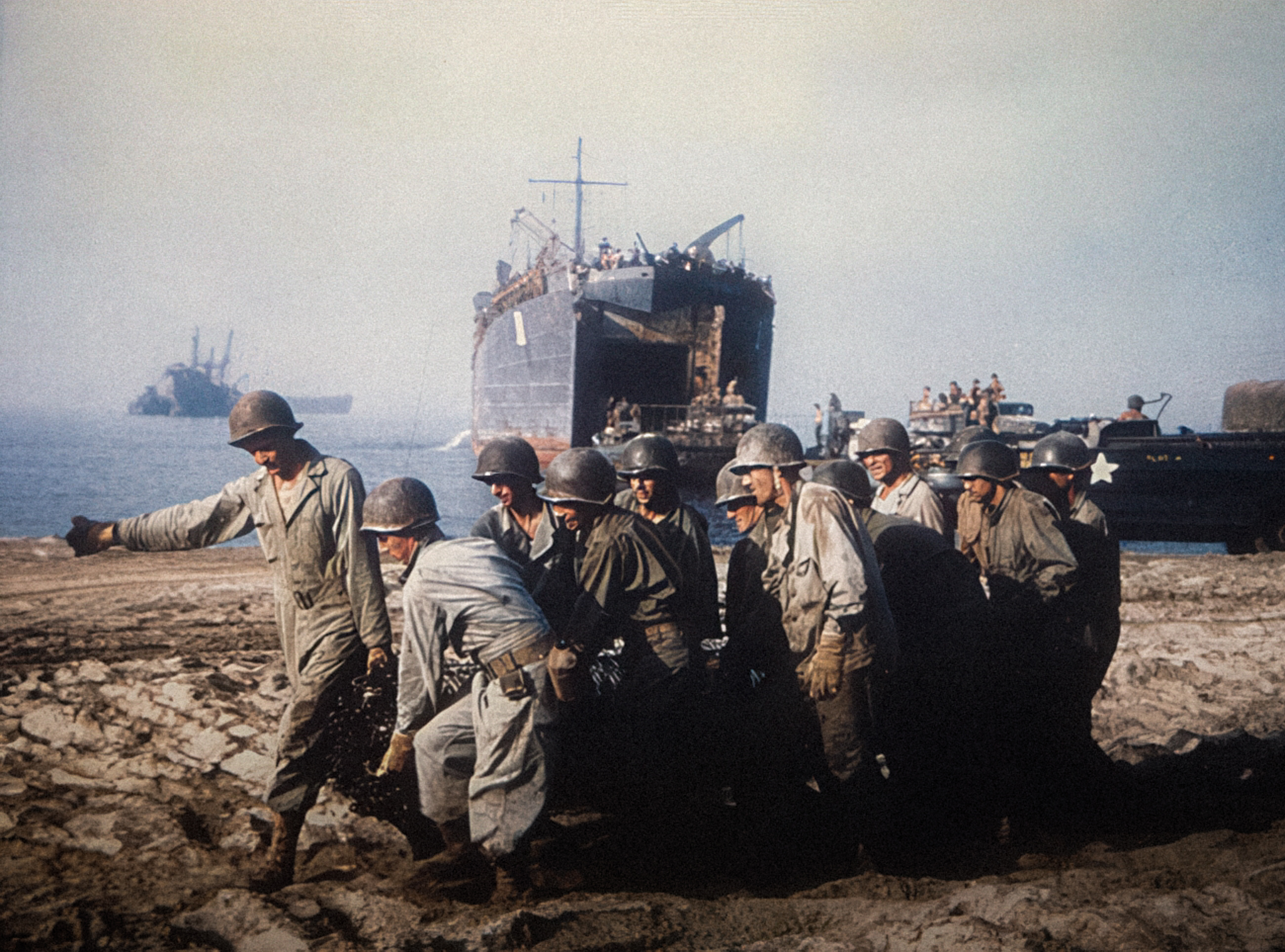 The War - US Army Engineers hauling a roll of wire mesh into position ...