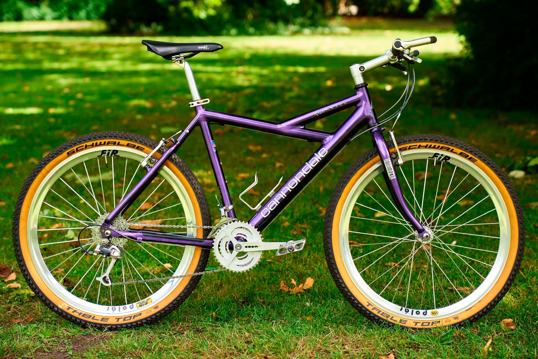 Purple Cannondale Killer V900 bike with orange tires