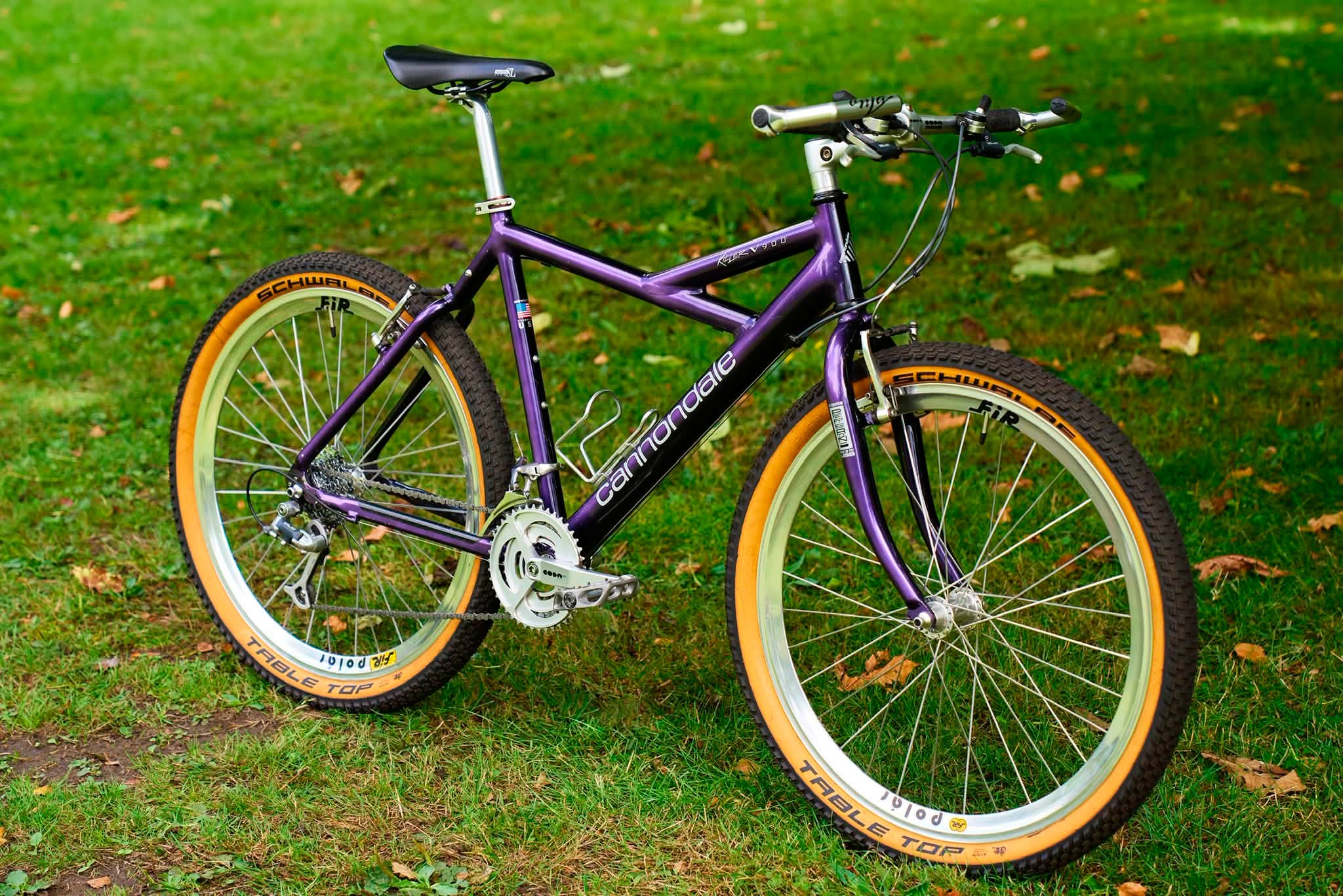 Purple Cannondale Killer V900 bike with orange tires