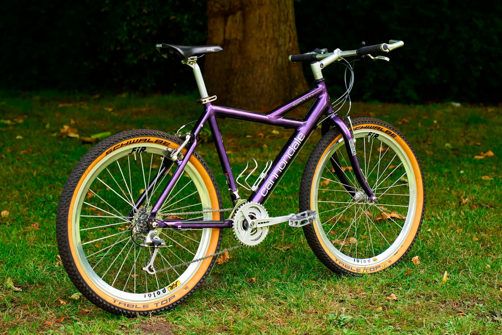 Purple Cannondale Killer V900 bike with orange tires