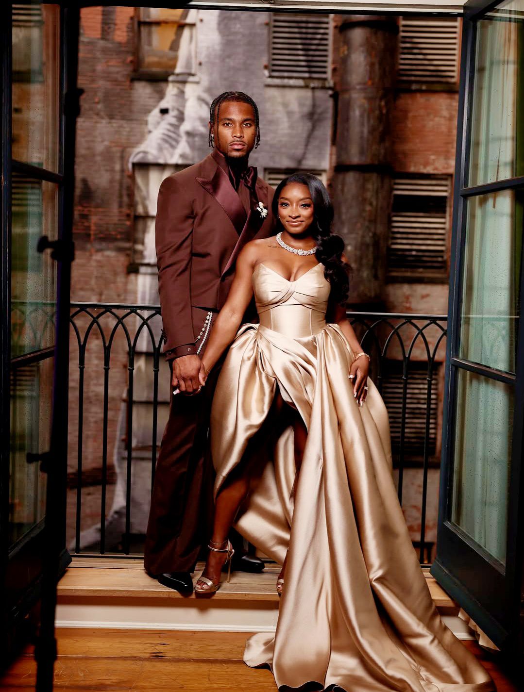 formal dress couple poses on staircase in champagne and brown attire homecoming dress tiered