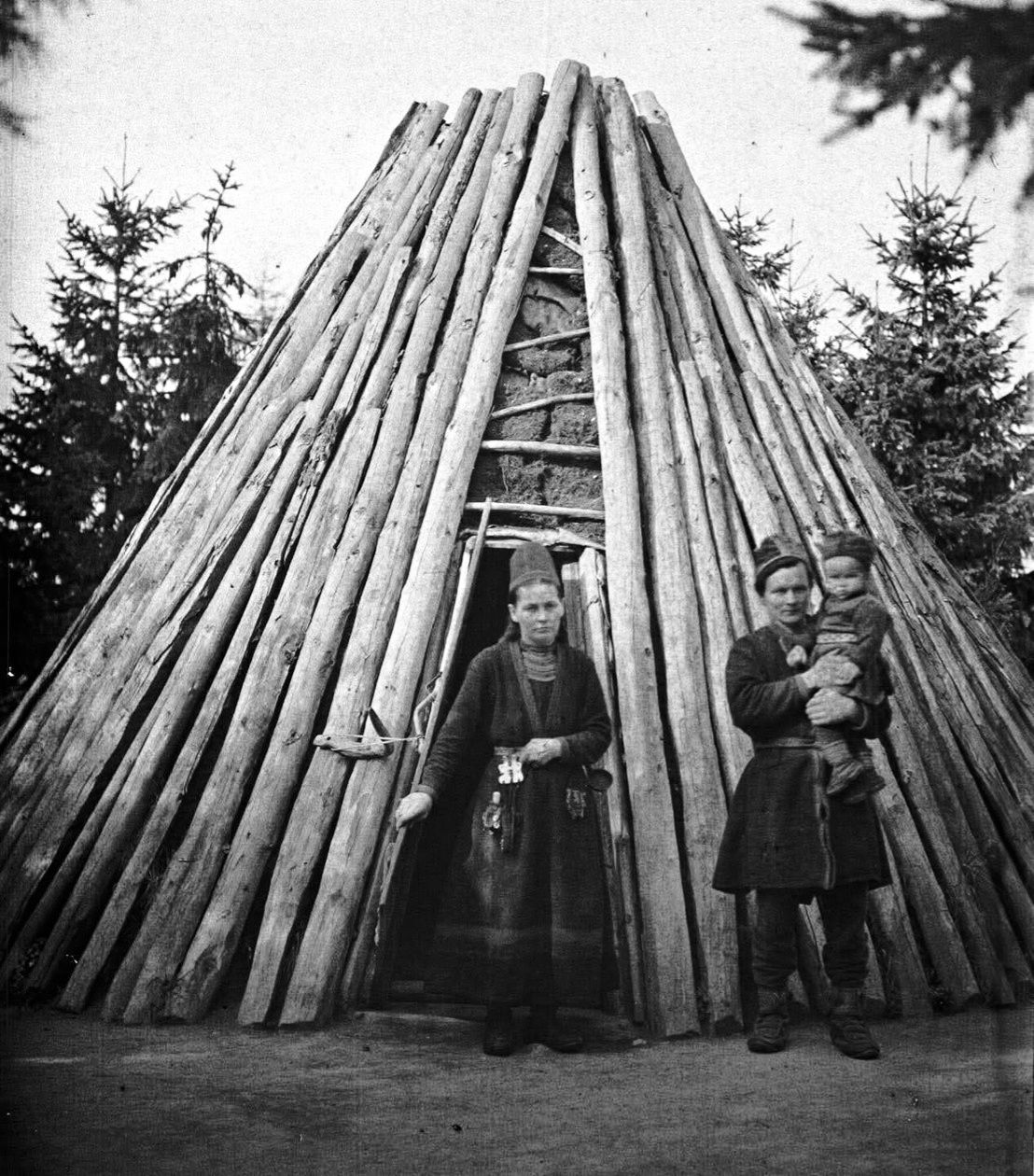 Swedish Sámi Family in front of their traditional dwelling in