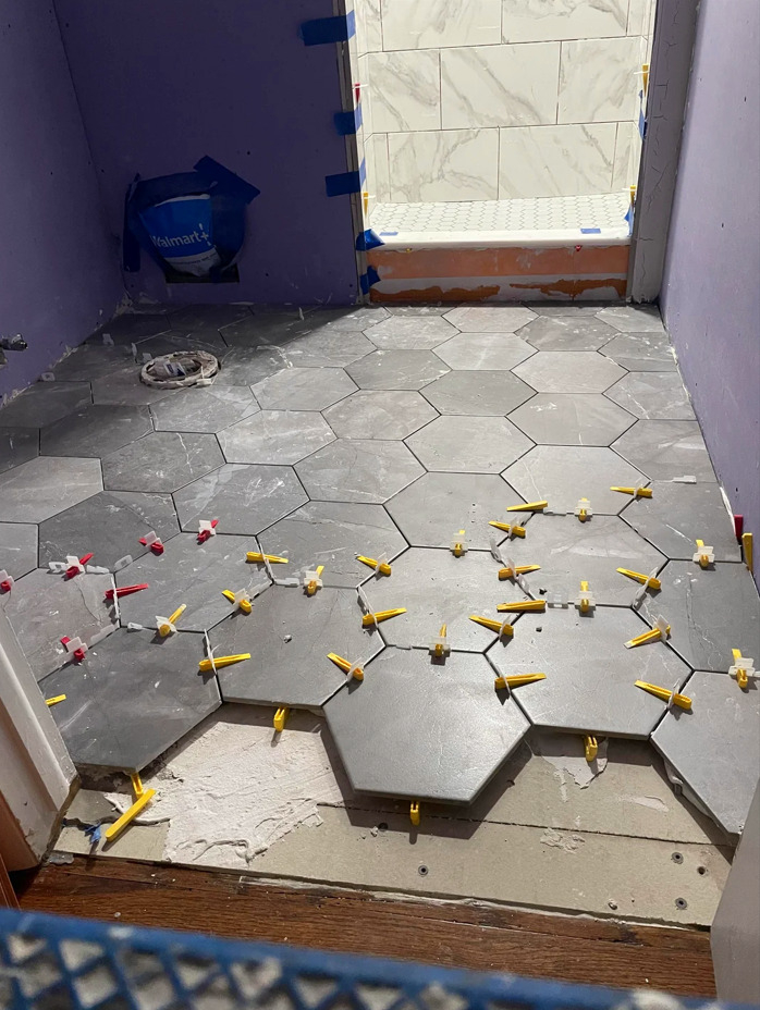 George - Is this a bad tile job? Having the bathroom floor tiled by a ...