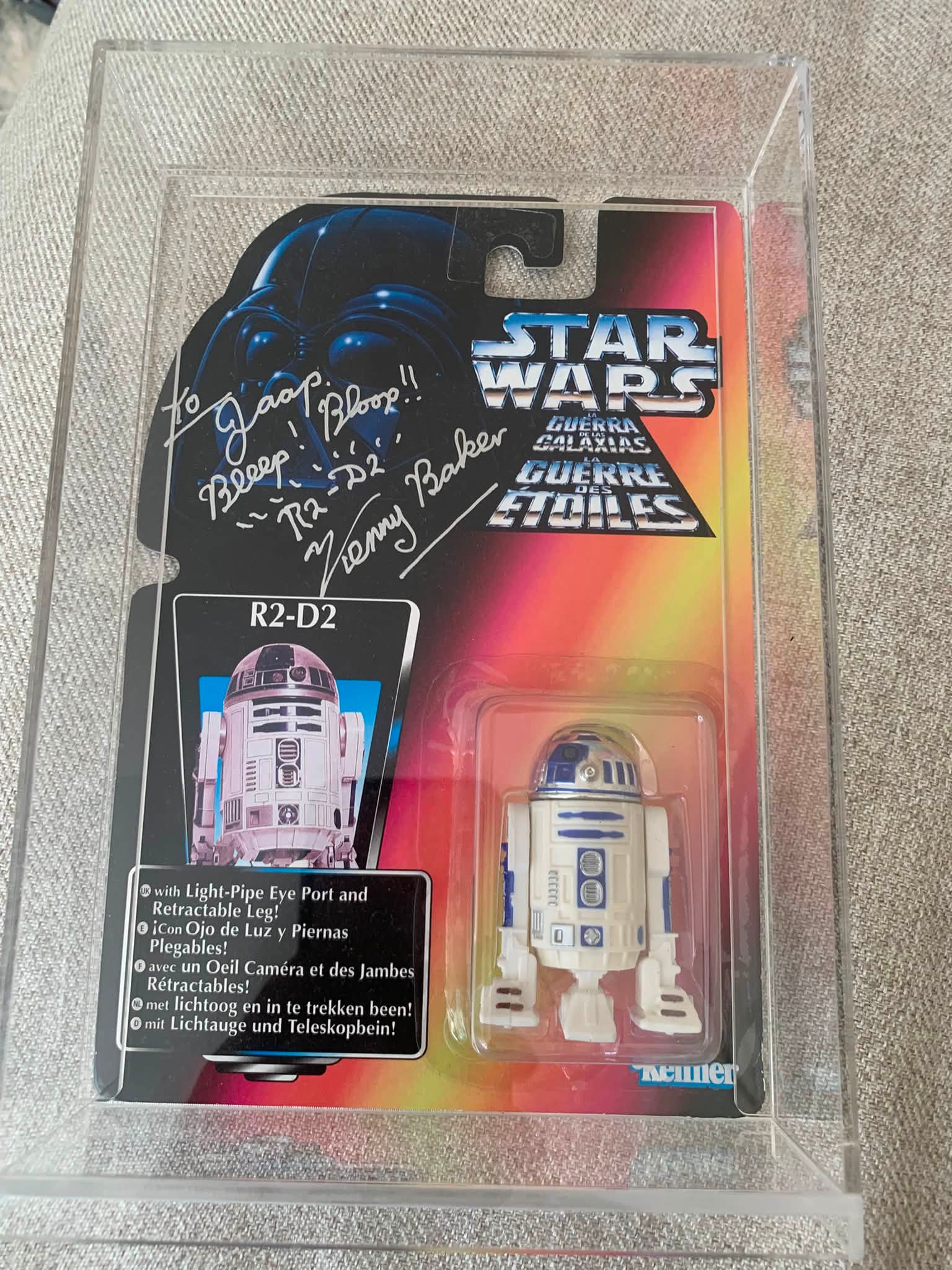 This is a signed/autographed R2D2 collectible figure. Kenny Baker