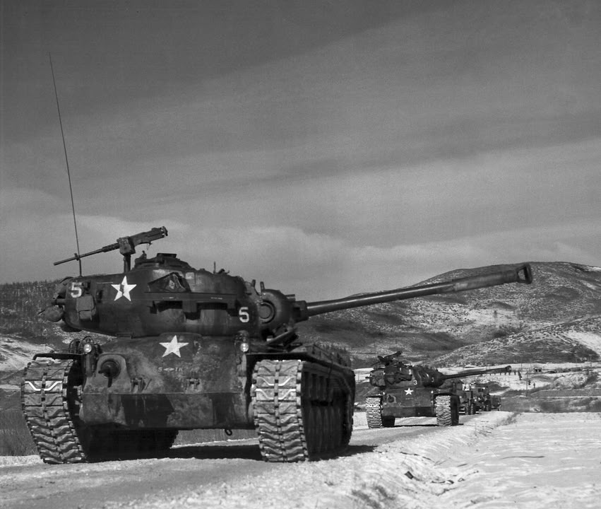 The War - A column of Marine M-26 Pershing tanks roll south, keeping ...