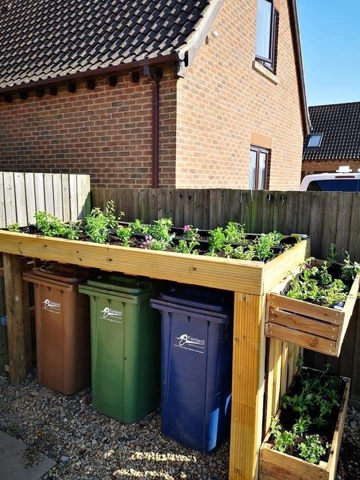 Top - I repurposed old trash bins by creating a covered planter station ...