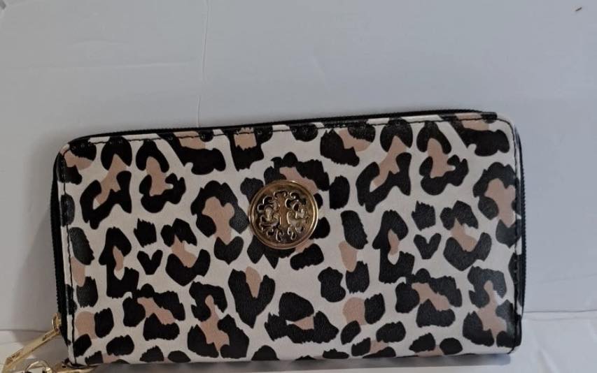 Lost white and tan leopard wallet with gold zipper near Jackson's