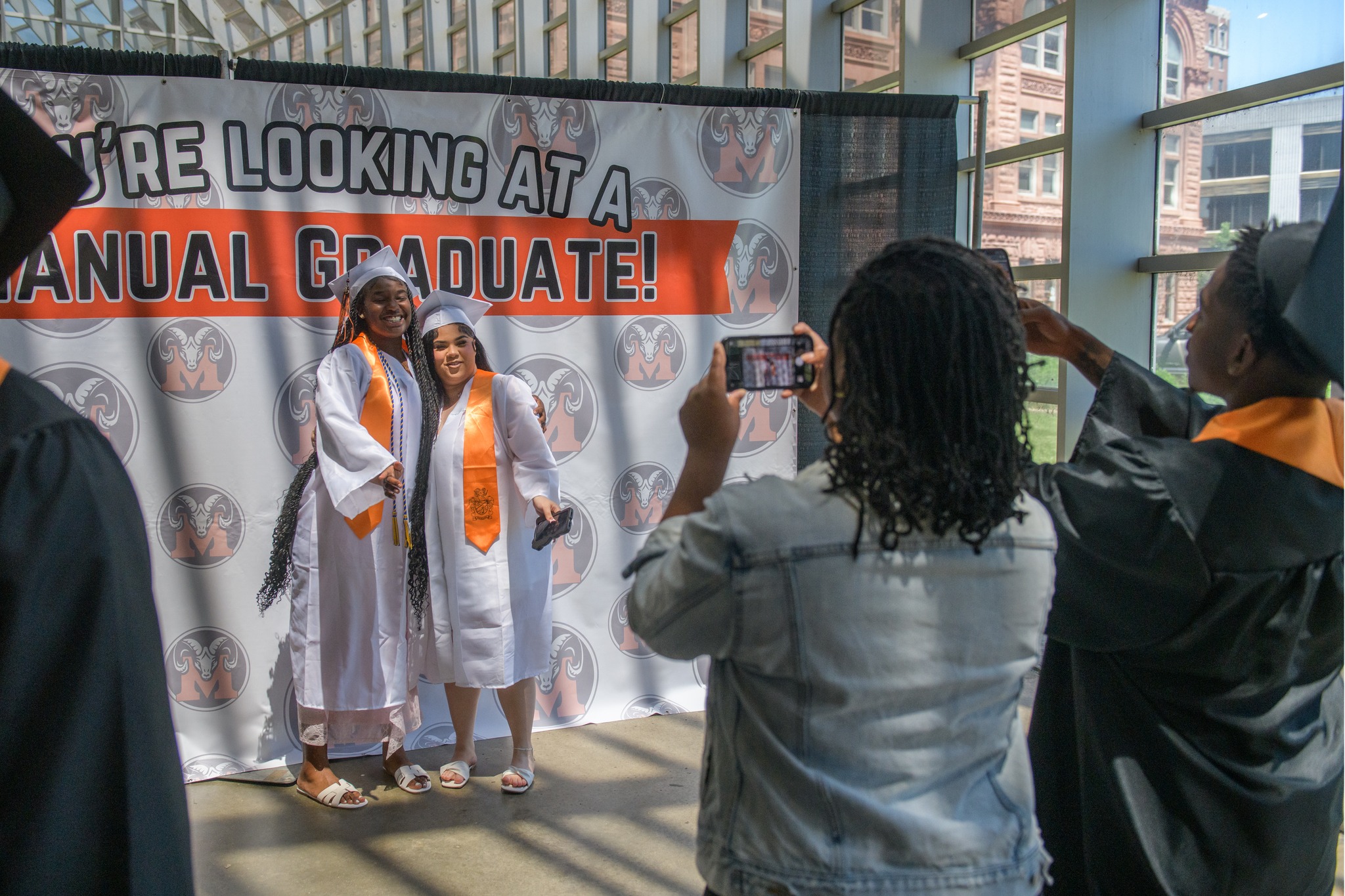 Journal - A pair of Manual High School graduates pose for photos before ...