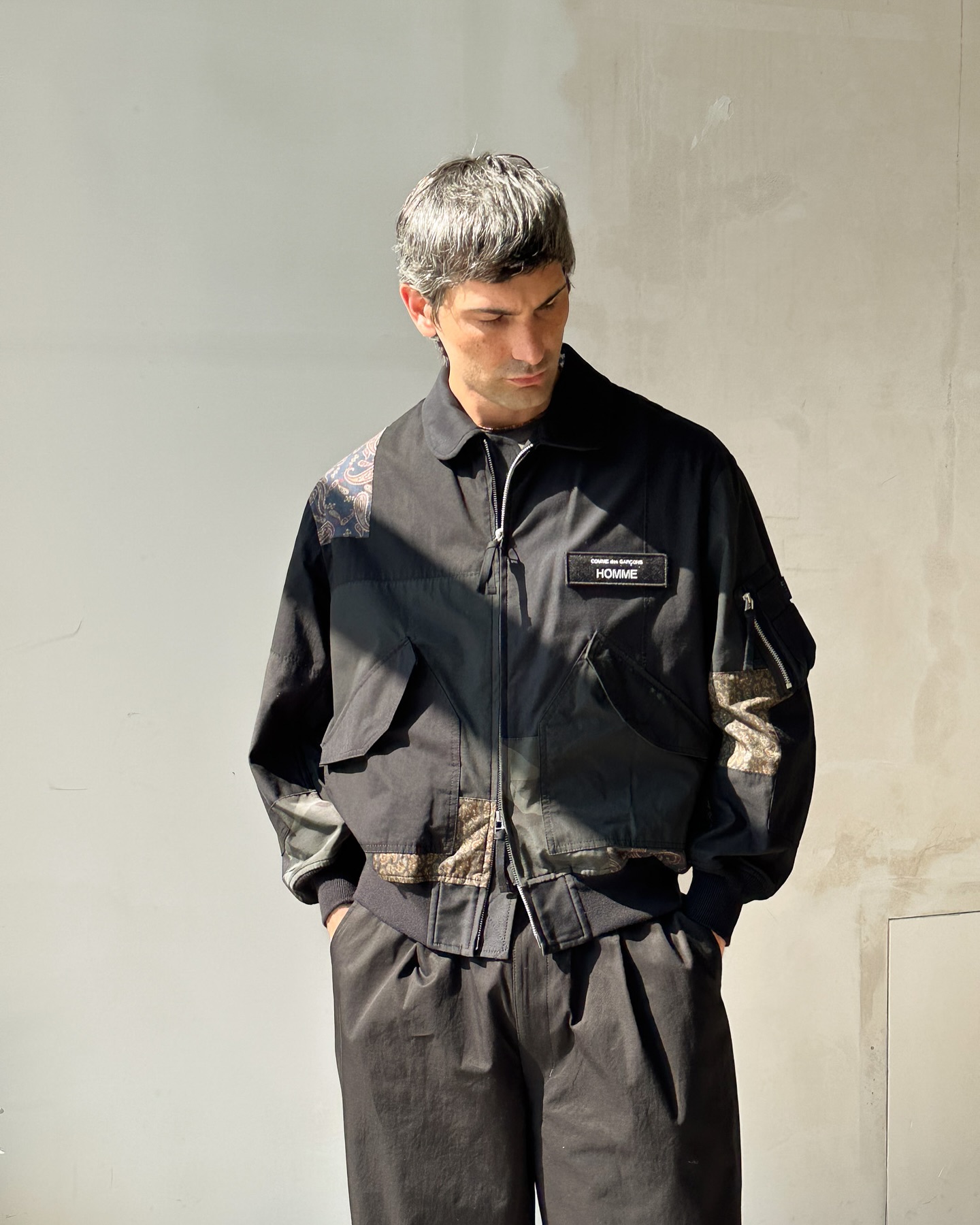 The Comme des Garçons HOMME Patchwork Bomber Jacket fuses military 