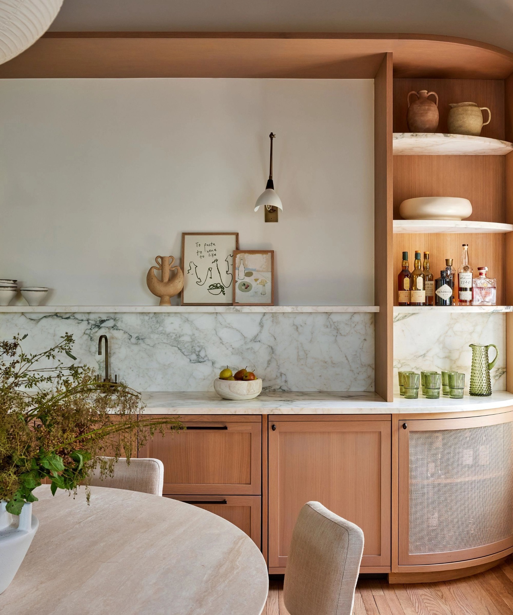 Homes - This home bar features a beautiful curved design with open ...