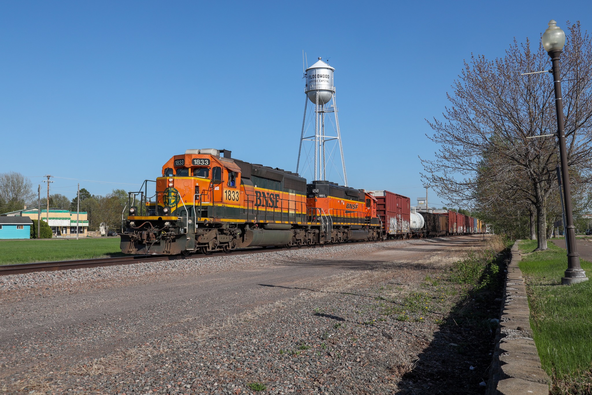 BNSF 1833 train with two orange SD40-2s in Cloquet