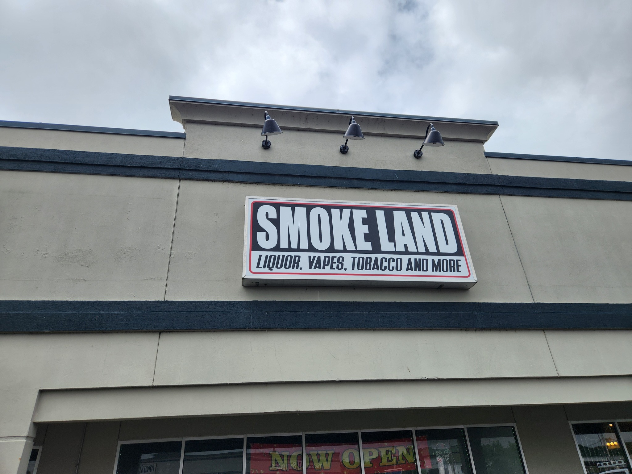 giant tobacco shop Smoke Land in Valley Park got a total face change in their existing box  sign. We often use giant suction cups to help with this 4' x 12' face  installation