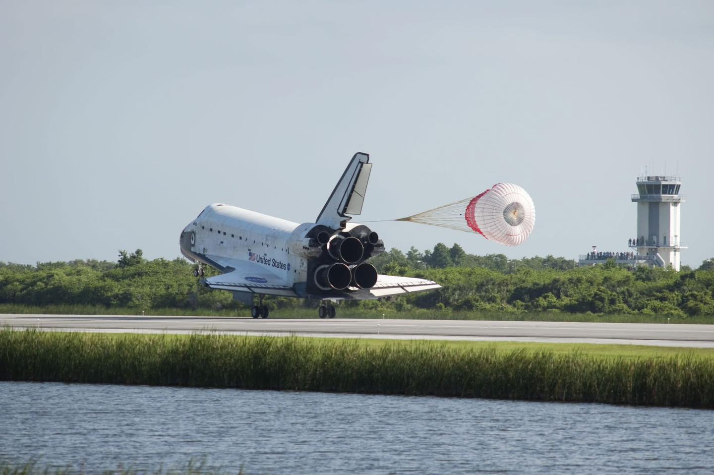 Space - Space Shuttle Atlantis deploys its drag chute as it rolls to a ...