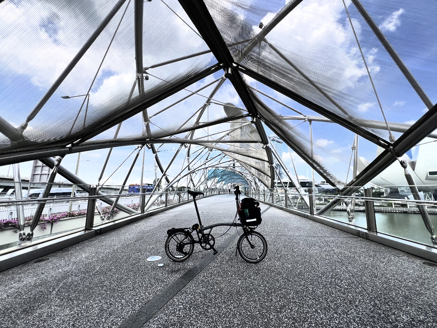 808 - Iconic steel folding bicycle on an iconic steel pedestrian bridge ...