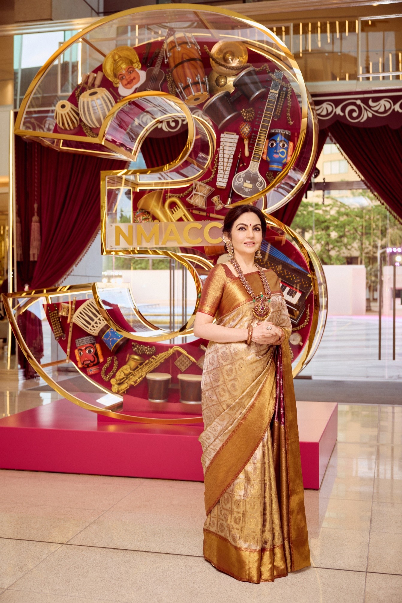 Mrs. Nita Ambani celebrated NMACC's 3rd anniversary in an exquisite ivory- gold Kanjivaram saree from Swadesh. Handwoven by master artisan R. Varadhan, this beautiful saree took over four months to complete. The ensemble