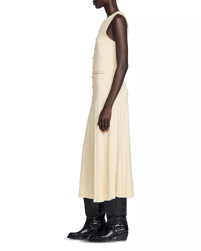 Sandro's Naima in Viscose-blend midi dress captures effortless Parisian elegance. Designed in France, the soft knitted silhouette has a button-through bodice, welt pockets and a pleated midi skirt. Size 36EUR/S • Color