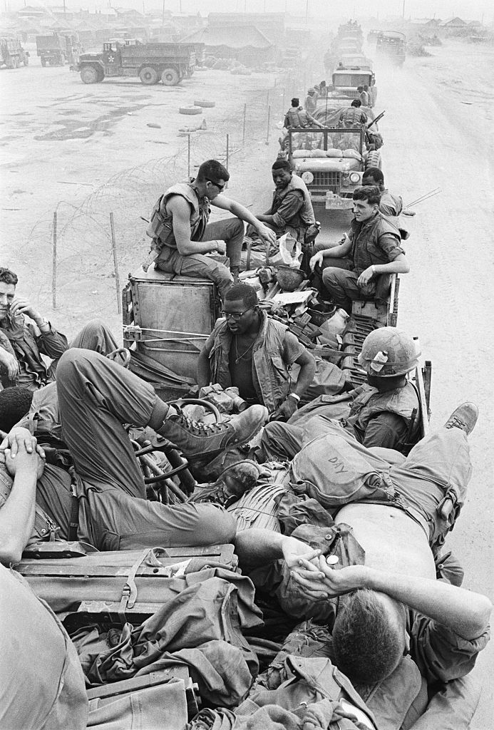 War - US soldiers from the 1st Cavalry rest on trucks in a convoy ...