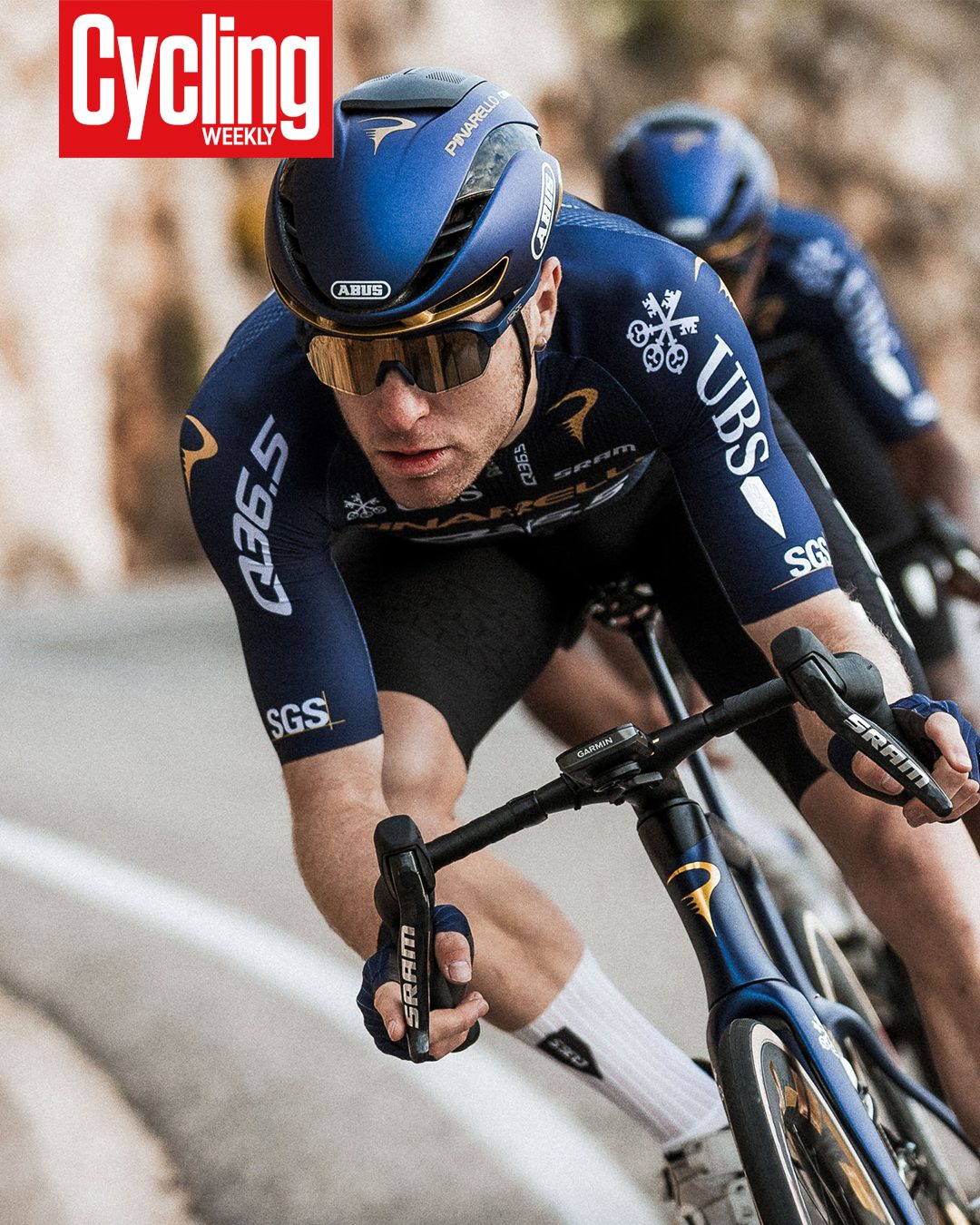 Pinarello-Q36.5's 2026 navy blue cycling kit with gold accents