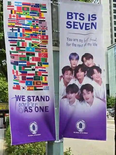 Which countries' flags are in the BTS poster in South Korea?