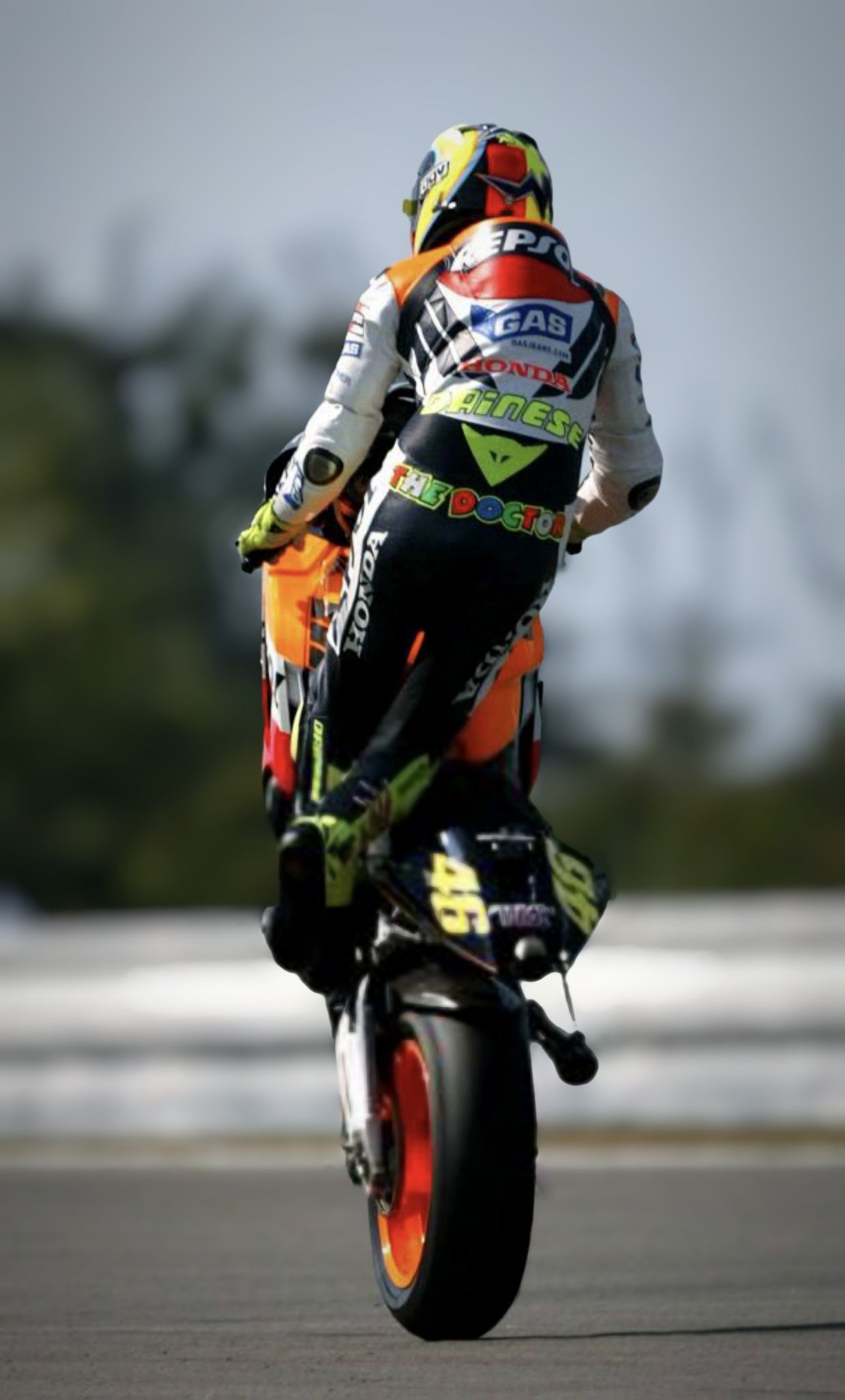 Valentino Rossi's signature cross leg wheelie at Motogp Brno 2003