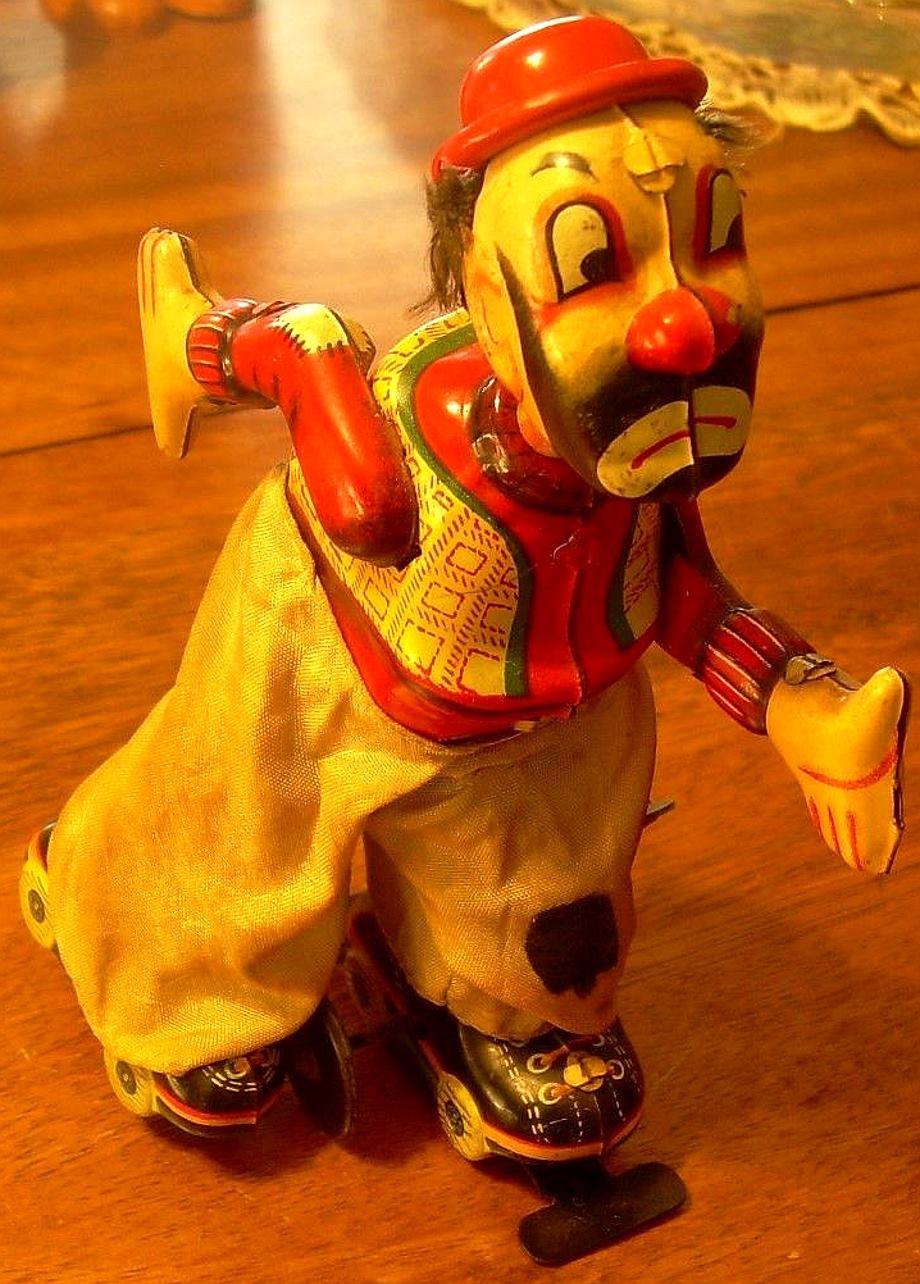 Vintage clown on roller skate toy