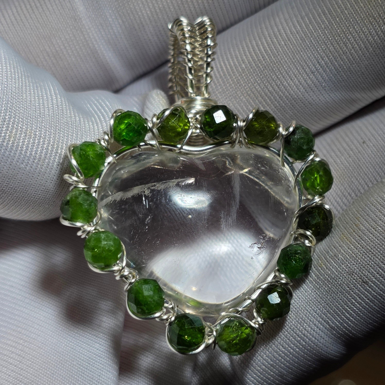 ? A crystal heart. Ringed with green. Made entirely by hand. This 