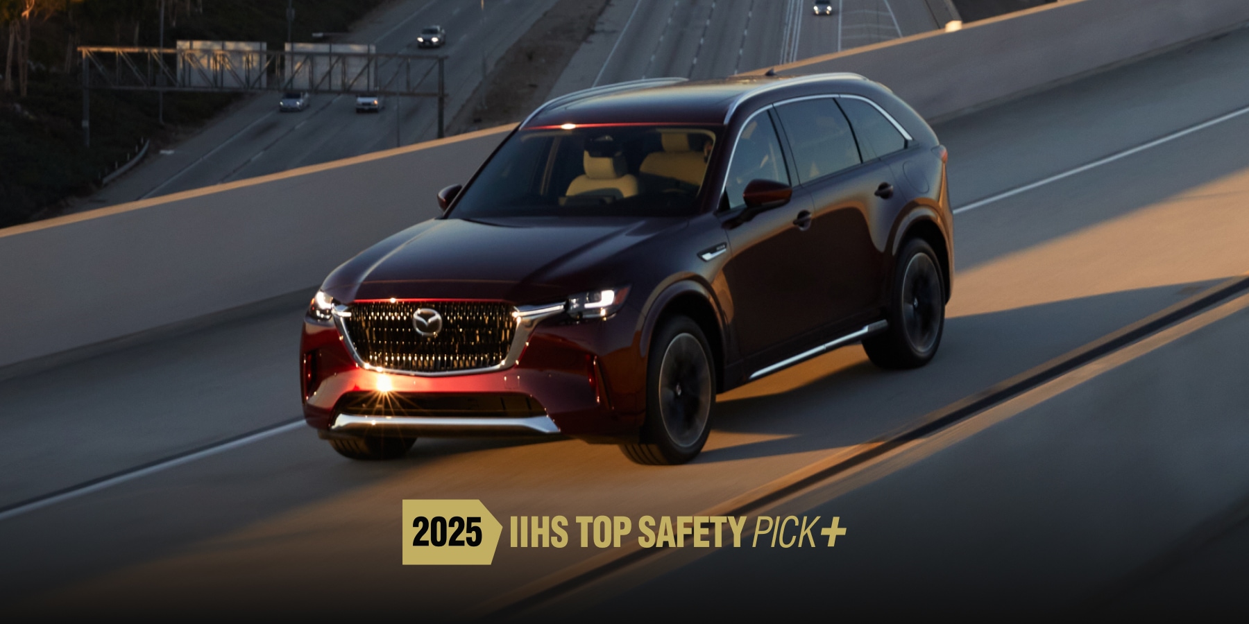 2026 Nissan Rogue driving through a cityscape at dusk, highlighting its sleek design and advanced safety features.