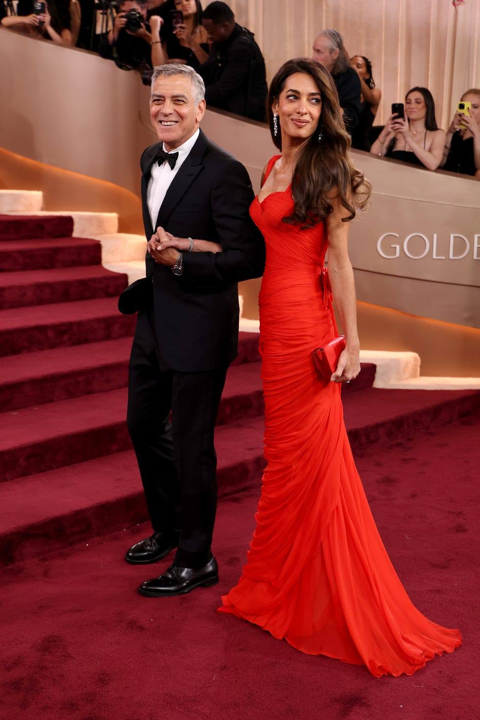 Amal Clooney and George Clooney ar the 2026 Golden Globes. George is in Armani. Amal turning heads in a ruched coral-red Pierre Balmain (@balmain) haute couture gown from Fall 1957, #AmalClooney #GeorgeClooney #