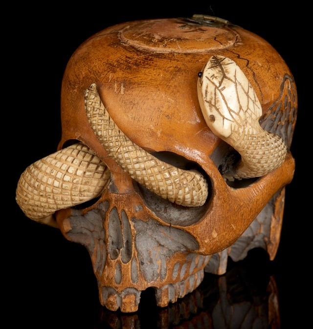 Tobacco jar shaped like a skull with snake
