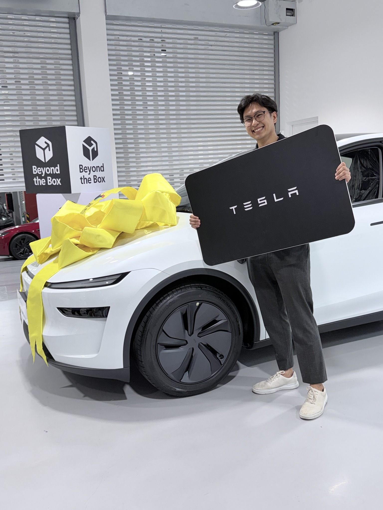 Unbox - Meet the lucky winner of a Tesla Model Y from... | Facebook