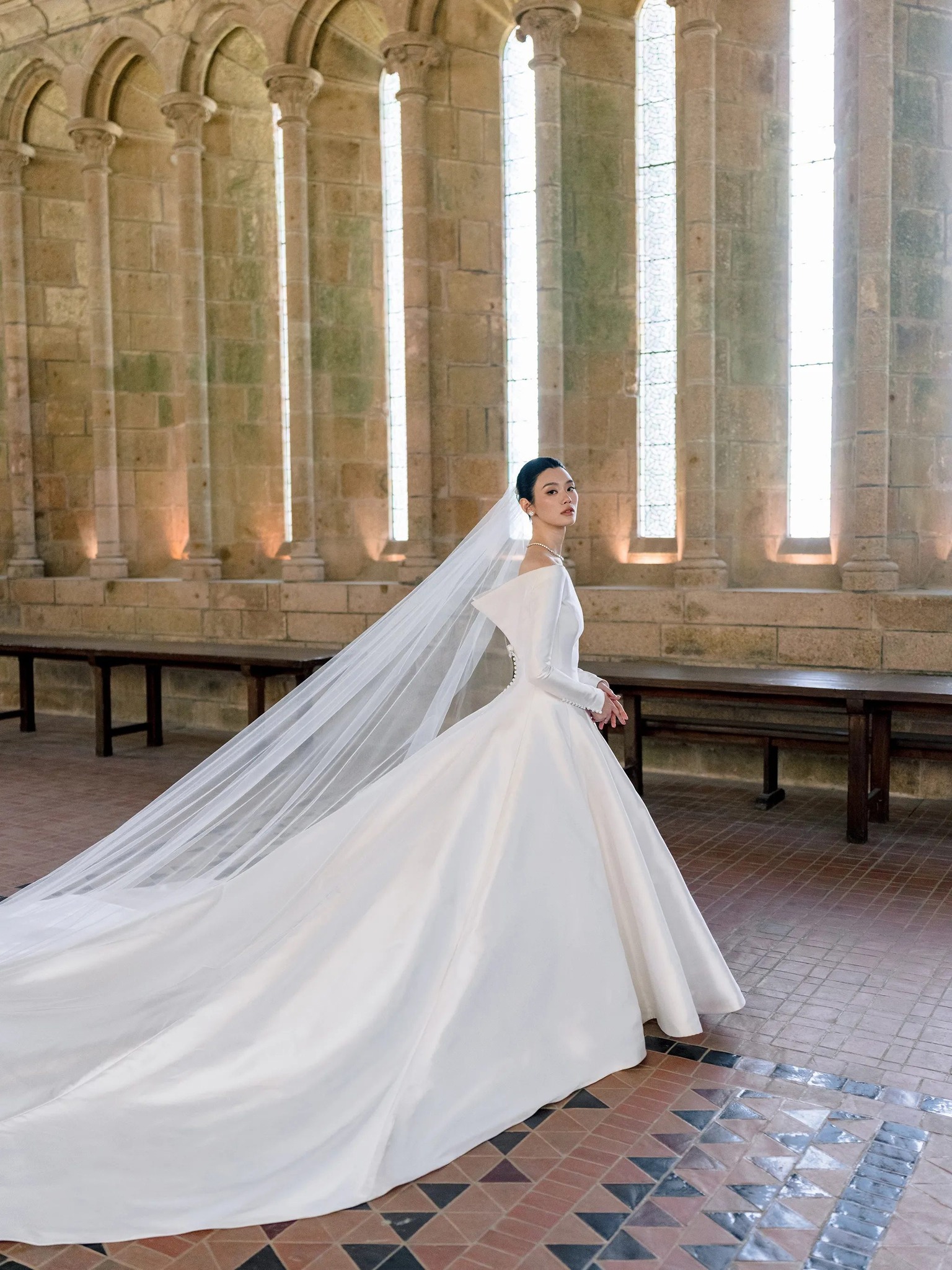 🔗: https://voguemagazine.visitlink.me/XVBKKQ Chinese model Ming Xi wore a custom Dior Haute Couture dress to marry entrepreneur Mario Ho at Mont Saint-Michel in Normandy, France. At the link, see more from the newlyweds'
