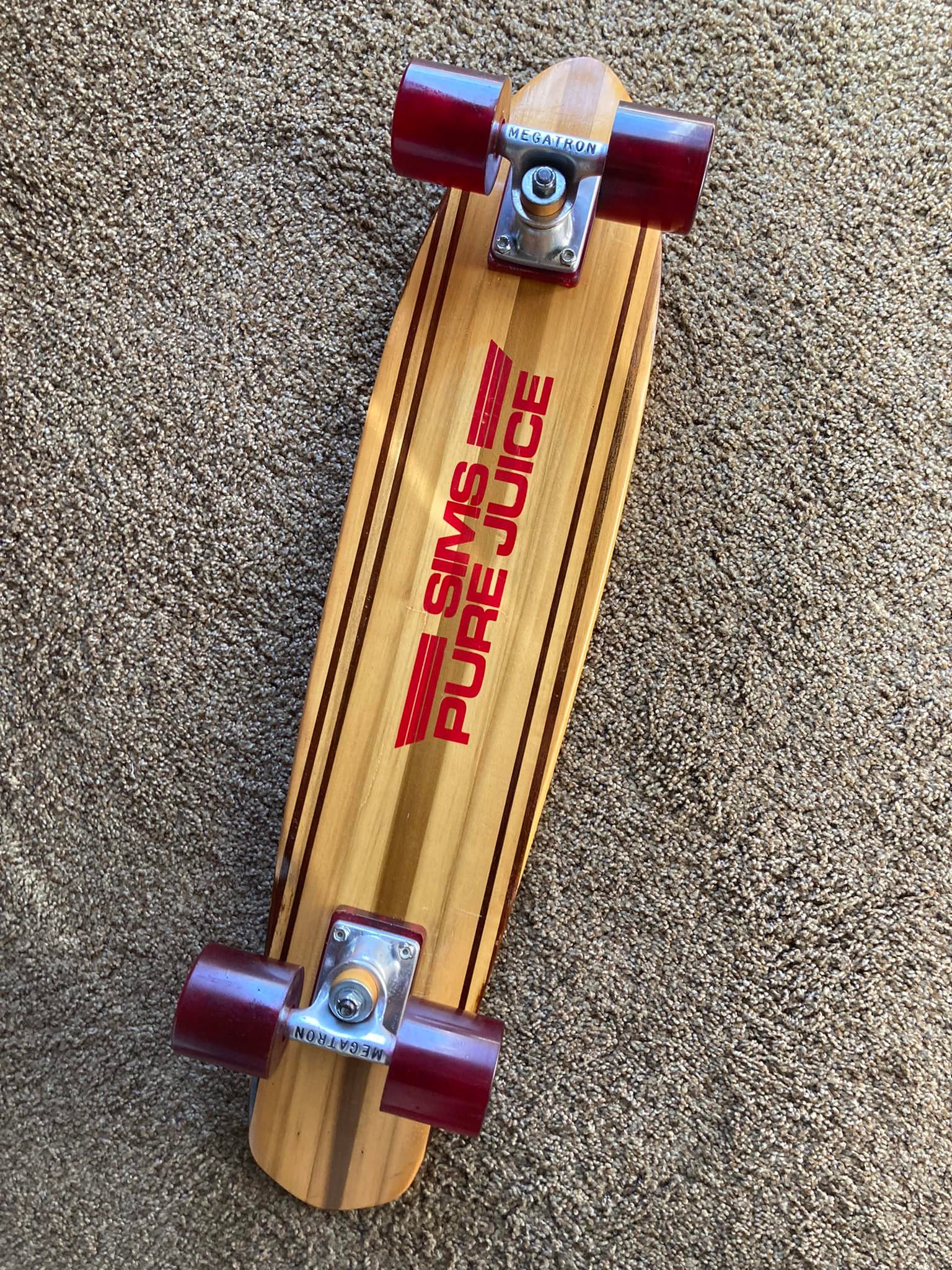 Nos Sims Taperkick skateboard with Pure Juice wheels and Megatron