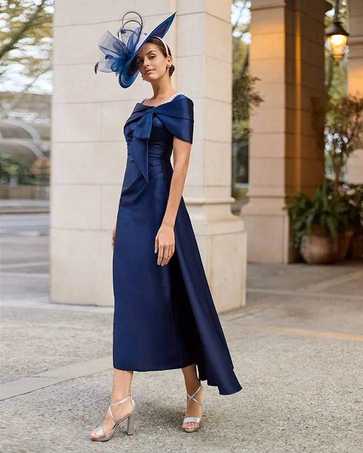 💎PEARLS & NAVY💎 A navy dress is a forever classic, and pearl embellishments only add more glamour! More details online: https://sineadsboutique.com/product/couture-club-dress-with-bow-pearl -on-neckline-mika-navy