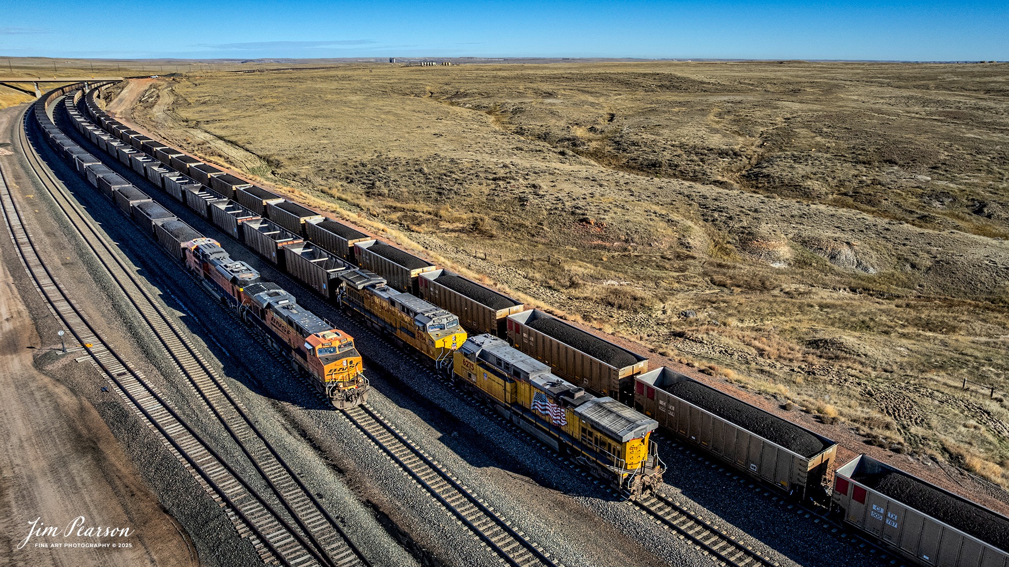 Jim - Two loaded outbound BNSF coal trains pass an inbound Union ...