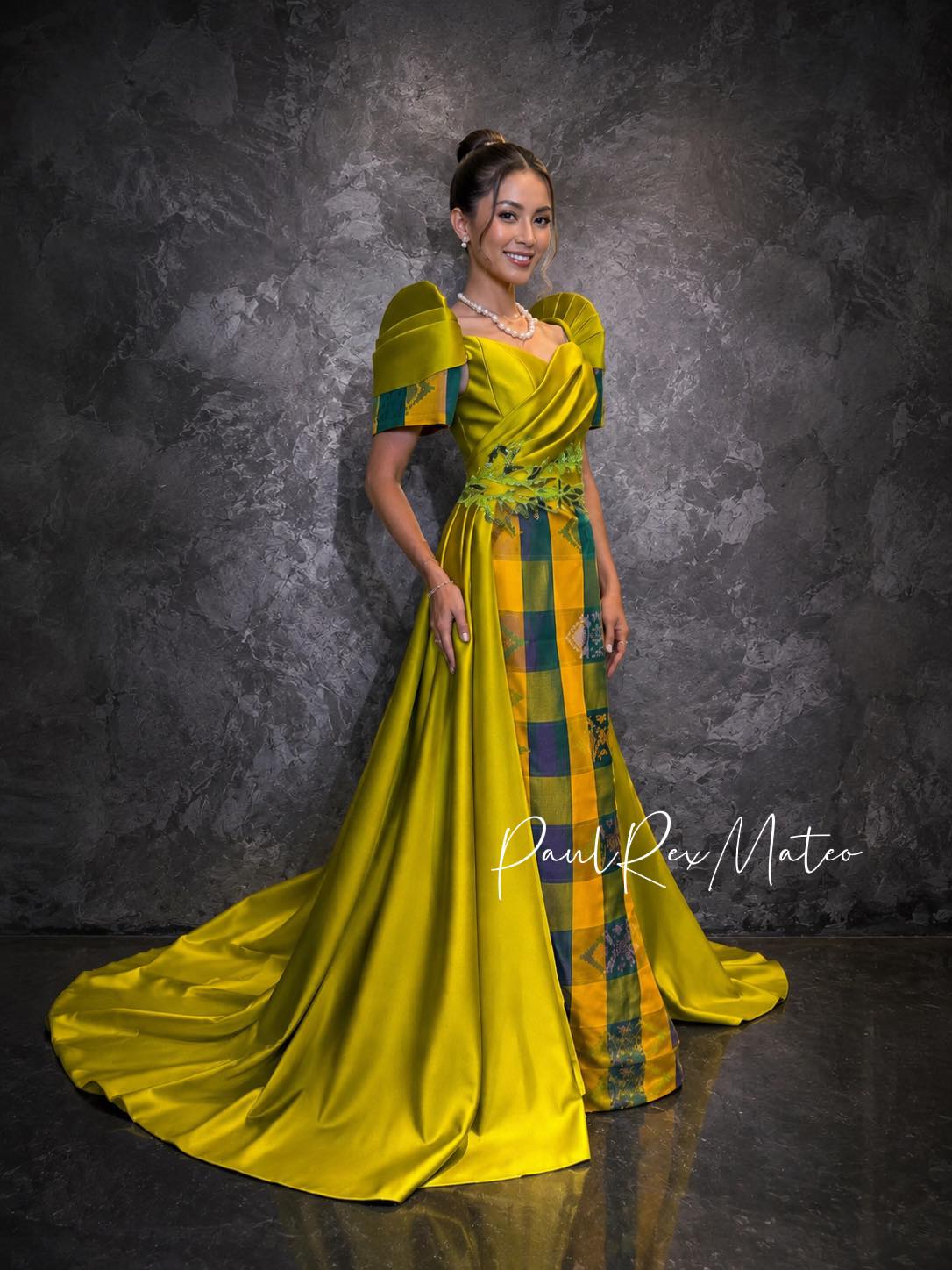 gold filipiniana dress A sophisticated gown in a striking mustard yellow hue, showcasing bold sculpted sleeves, an elegantly draped bodice, and a lavish flowing train. The contemporary silhouette is enhanced by intricate traditional inaul modern filipiniana outfit ideas