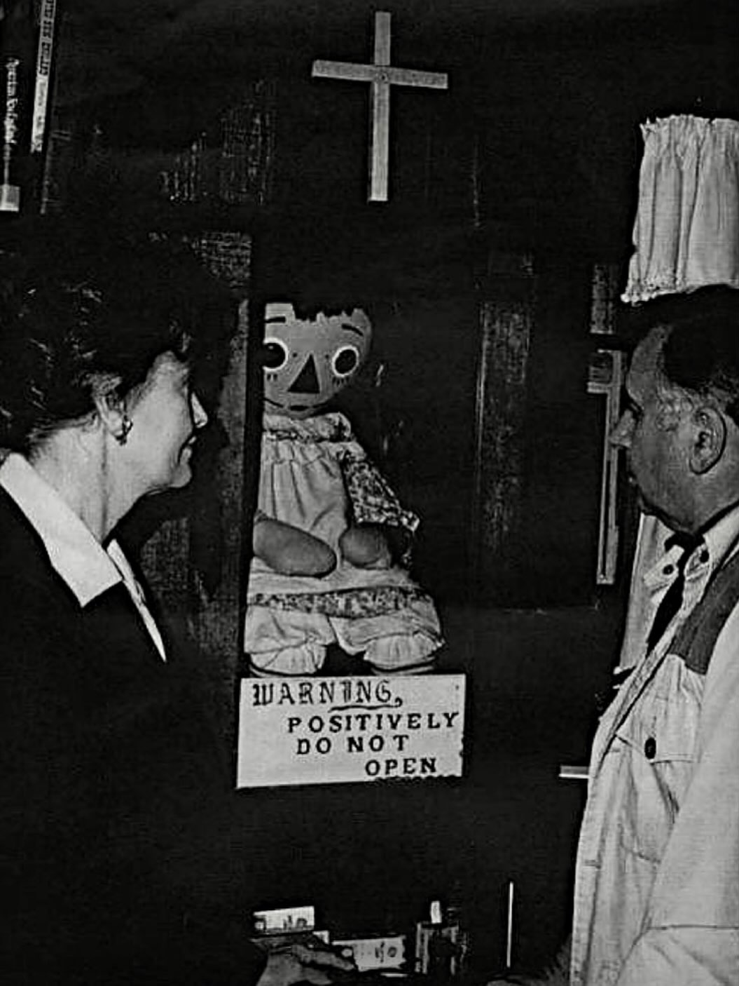The Jack - The image of Ed and Lorraine Warren gazing at the Annabelle doll enclosed within its ...
