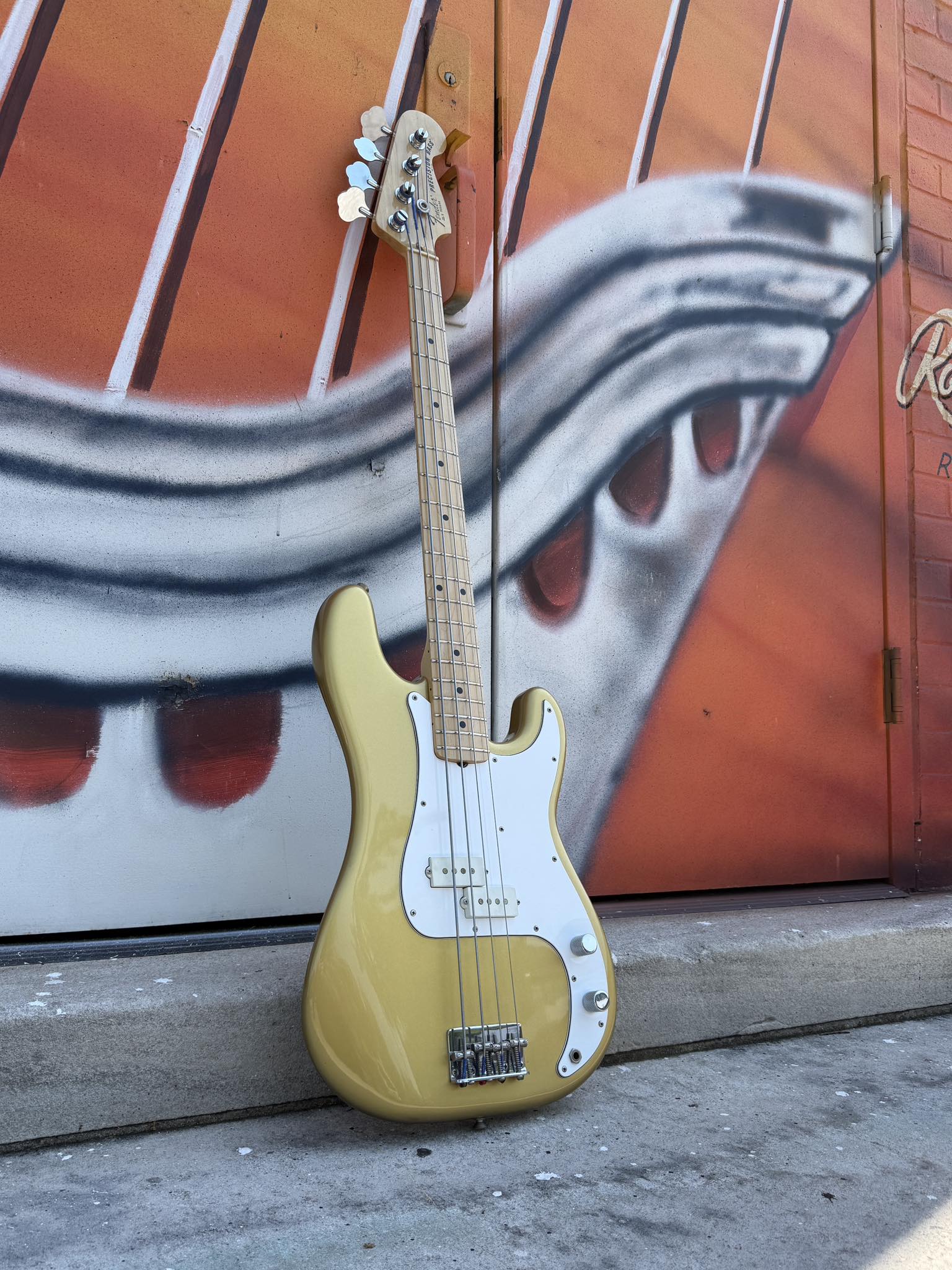 A 1981 Fender Precision in Aztec gold metallic finish, a custom