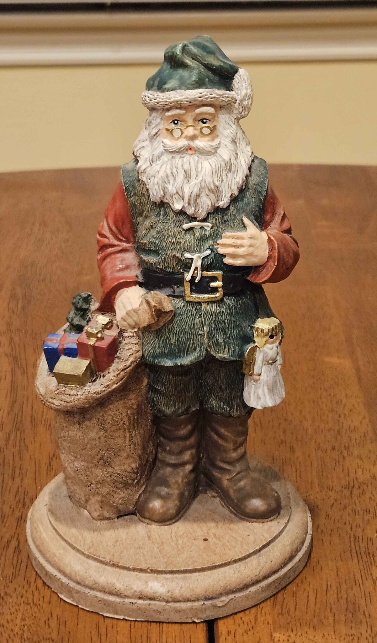 Vintage Santa with toy sack on his left and an angel doll on his