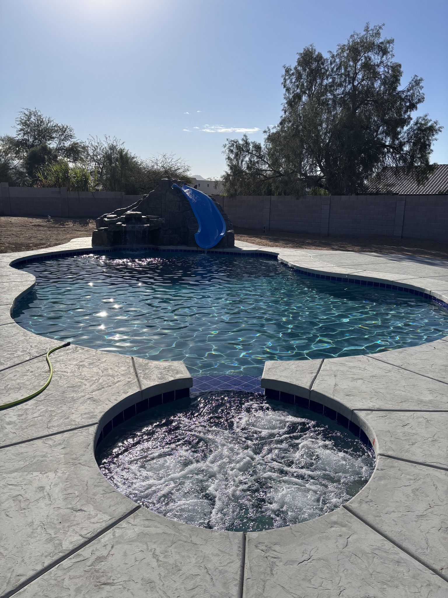 Pumping 8 yards of dark gray concrete out at The Bluffs in Yuma. Clean ...