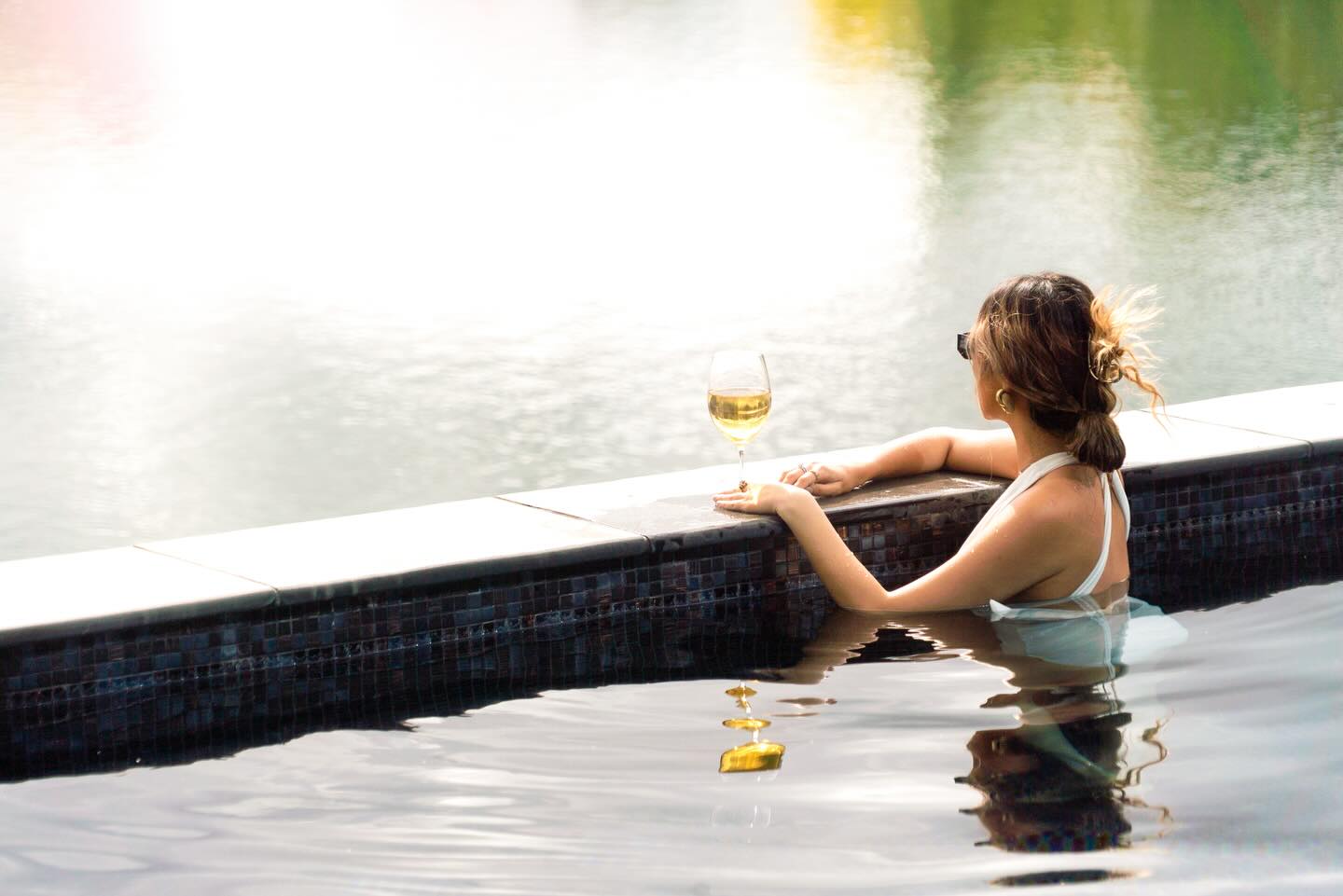 A quiet glass of wine by the water, golden hour settling in - The